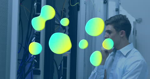 Technician Analyzing Data in Server Room with Abstract Overlay