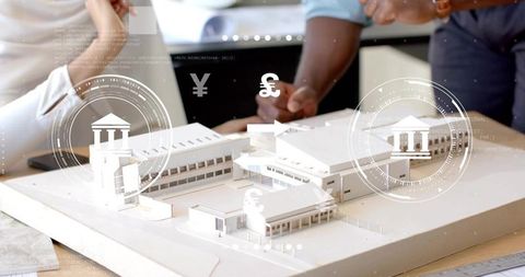 Architects Collaborating Over Model with Digital Currency Overlays