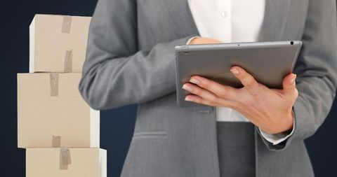 Businesswoman Using Tablet for Inventory Management