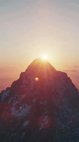 Sun Rising Over Alpine Summit, Casting Golden Flare and Lighting Snow Patches