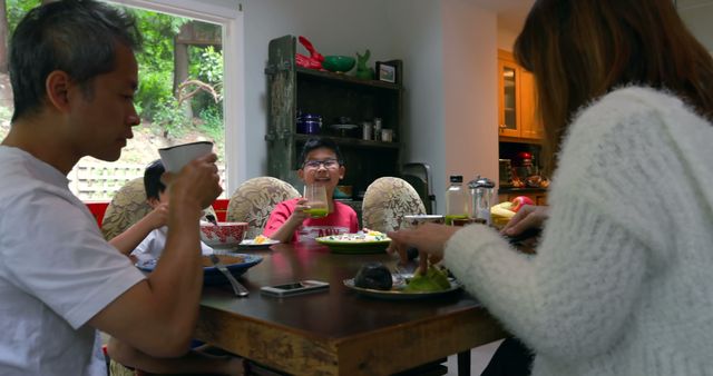 Family Enjoying Meal Together at Dining Table - Download Free Stock Images Pikwizard.com