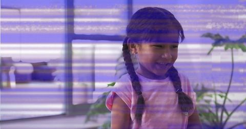 Smiling girl wearing light-pink top and hoops near plants with purple glitch overlay