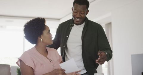 African american couple reviewing financial documents at home