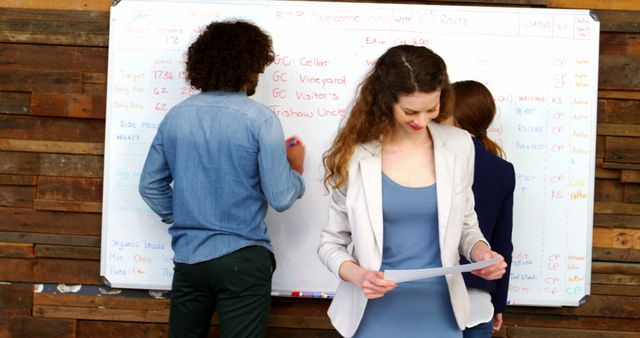 Young Business Team Discussing and Planning Strategy at Whiteboard - Download Free Stock Images Pikwizard.com