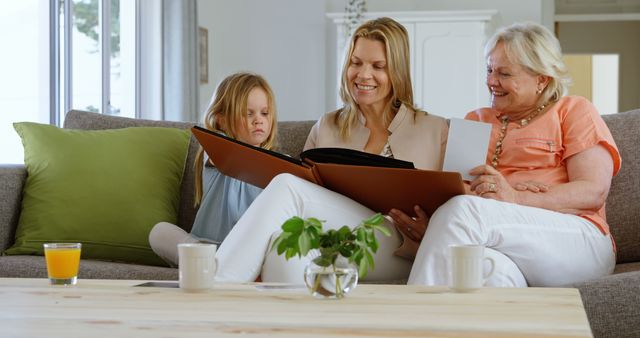 Three Generations Bonding over Family Album - Download Free Stock Images Pikwizard.com