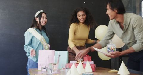 Colleagues Celebrating and Tidying Up After Baby Shower at Office