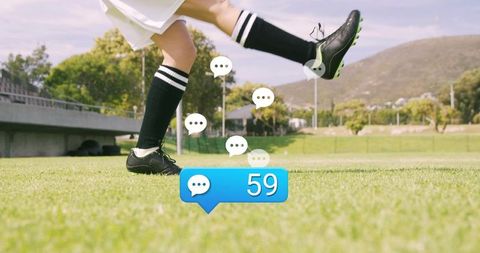 Football player kicking ball with digital chat display on soccer field