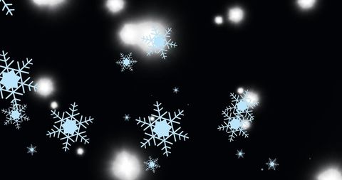 Snowflakes and subtle light on black festive backdrop