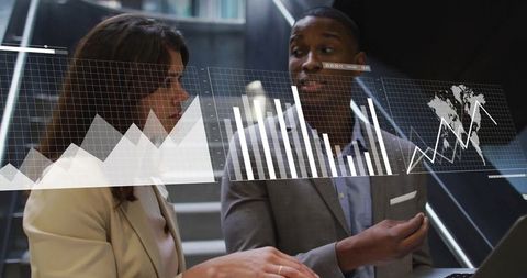 Business Colleagues Analyzing Financial Graphs in Modern Office Environment