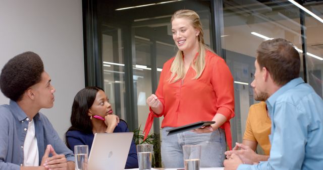 Confident Businesswoman Presenting to Colleagues in Modern Office - Download Free Stock Images Pikwizard.com