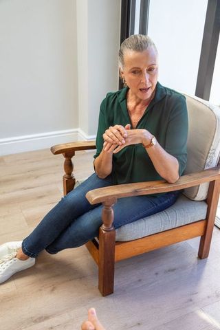 Senior woman conversing in comfortable home setting