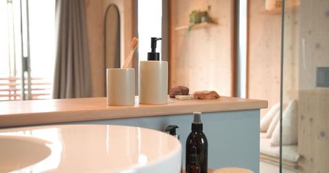 Minimalist bathroom vanity with dispenser and toothbrush holder