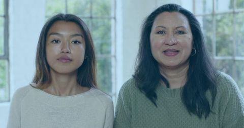 Multigenerational Women Posing in Knit Sweaters by Soft Window Light for Lifestyle Use