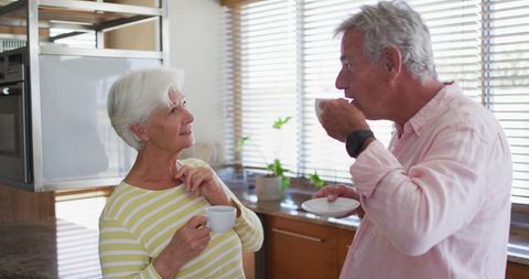Senior Couple Enjoying Coffee and Conversation in Kitchen - Download Free Stock Images Pikwizard.com