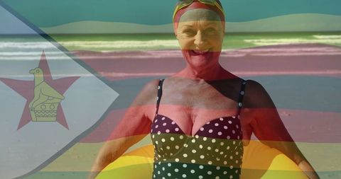 Joyful Senior Woman Relaxing at Beach with Inflatable Ring