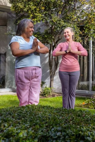 Senior Women Practicing Yoga Outdoors to Embrace Health