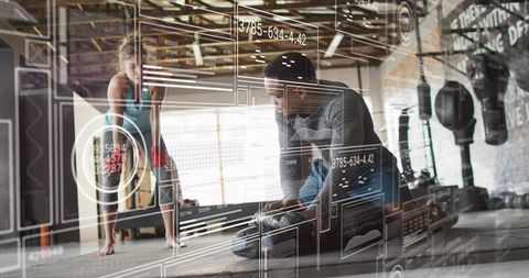 Trainer coaching client in industrial gym with ar fitness hud and performance metrics