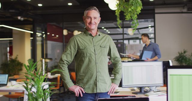 Confident Middle-Aged Businessman Posing in Modern Office Environment - Download Free Stock Images Pikwizard.com