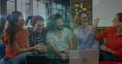 Mixed ethnicity team collaborating with digital interface overlay