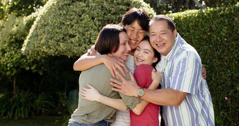 Happy Family Connecting Outdoors with Nature in Backyard