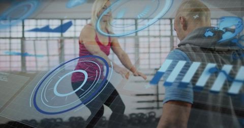 Female athlete squatting with trainer in gym with kettlebells and futuristic hud overlay