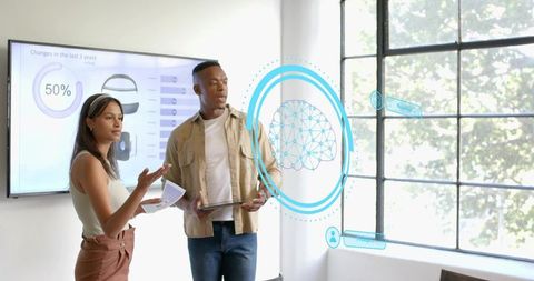 Presenting team reviewing holographic neural network visualization in bright modern office