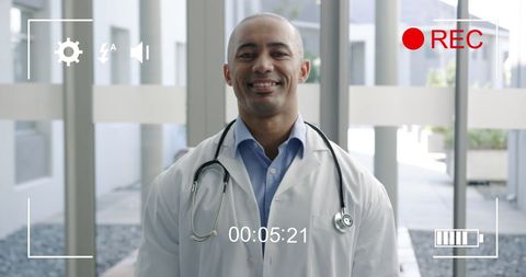 Friendly Male Doctor Smiling at Camera in Medical Setting - Download Free Stock Images Pikwizard.com