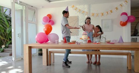 Family Celebrating Birthday with Confetti and Smiles