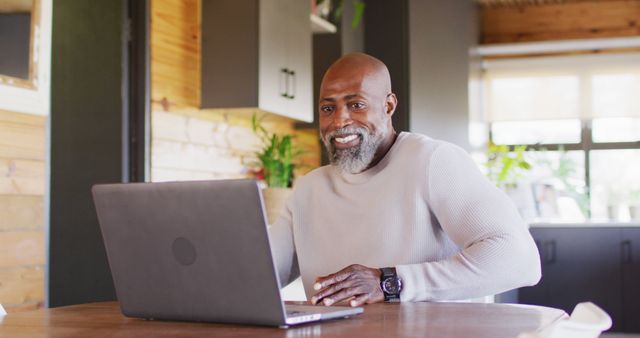 Smiling Mature Man Working on Laptop in Rustic Home Office - Download Free Stock Images Pikwizard.com