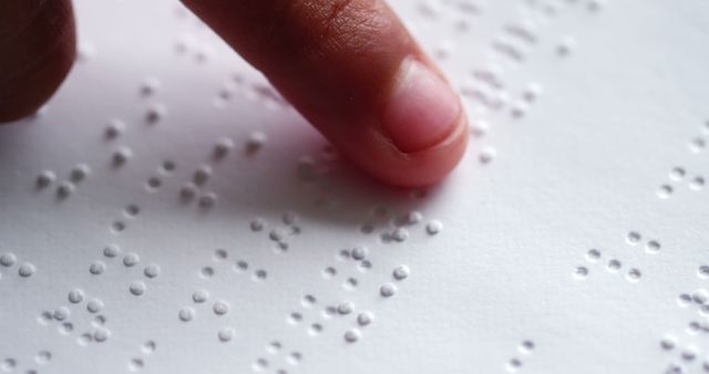 Close-Up of Finger Reading Braille Text on Paper - Download Free Stock Images Pikwizard.com