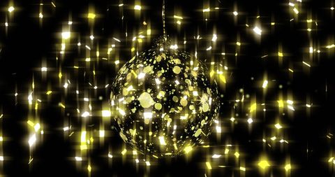 Golden Christmas Bauble with Falling Stars on Black Background