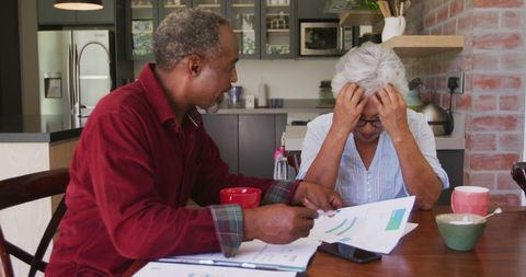 Senior Couple Discussing Financial Worries at Home