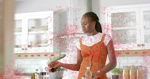 Woman reacting to meal while cooking in modern kitchen with range hood