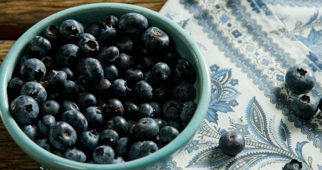 Fresh Blueberries in Ceramic Bowl on Decorative Fabric - Download Free Stock Images Pikwizard.com