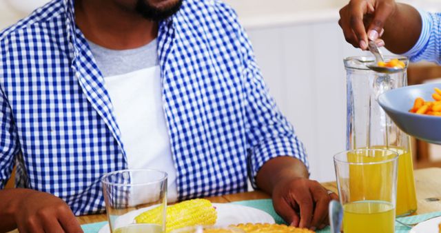 Family Dinner with Corn and Juice - Download Free Stock Images Pikwizard.com