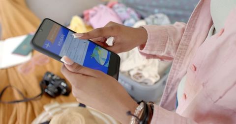 Young Woman Planning Trip on Smartphone