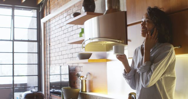 Smiling Woman Using Mobile Phone in Contemporary Kitchen - Download Free Stock Images Pikwizard.com