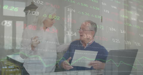 Senior Caucasian Couple Analyzing Finances with Stock Market Data Overlay