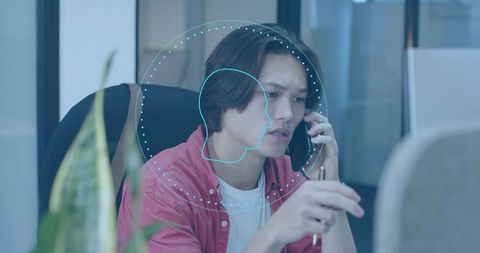 Young Professional Using Smartphone with Digital Interface in Modern Office