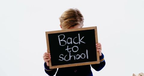 Child Holding Chalkboard Sign Celebrating Back to School Season - Download Free Stock Images Pikwizard.com