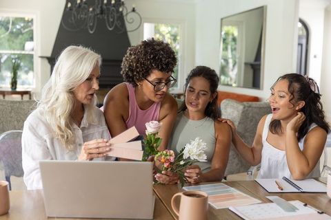 Multigenerational diverse women collaborating on color palette and floral styling for decor