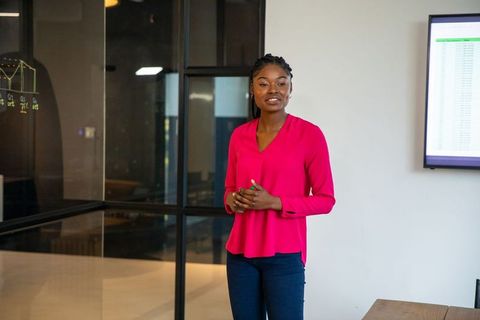 Confident Professional Presenting Trend Analysis in Modern Office