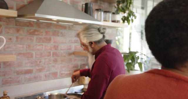 Senior Man with Gray Hair Cooking in Modern Kitchen - Download Free Stock Images Pikwizard.com