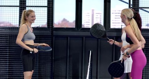 Female Friends Enjoying Padel Game in Urban Setting