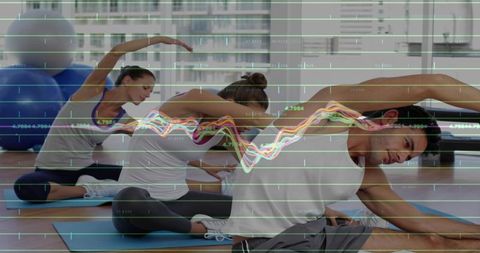 Mixed group stretching with colorful performance analytics overlay in modern gym studio