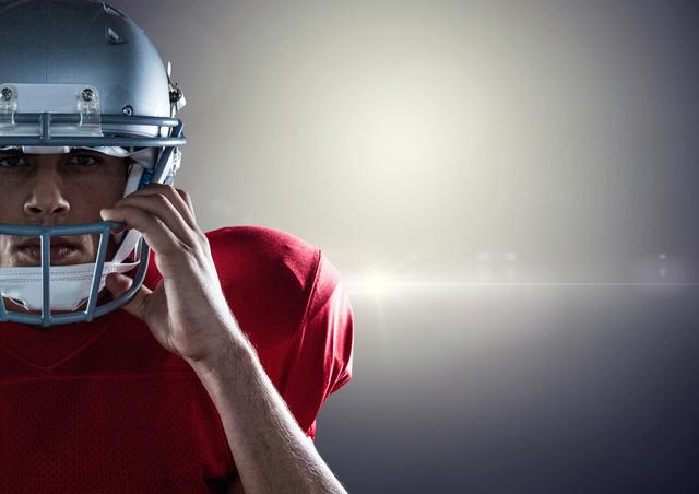 Digital composition of american football player holding helmet against grey background