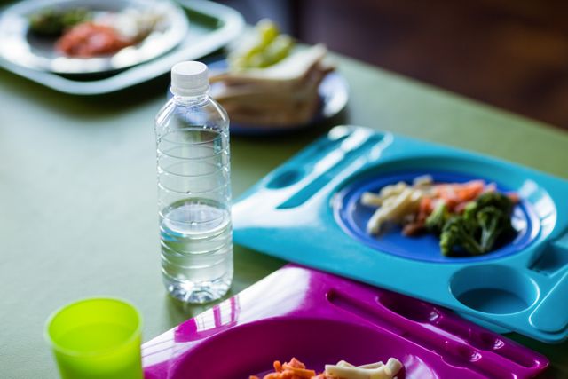 High angle view of food with water bottles on table in canteen