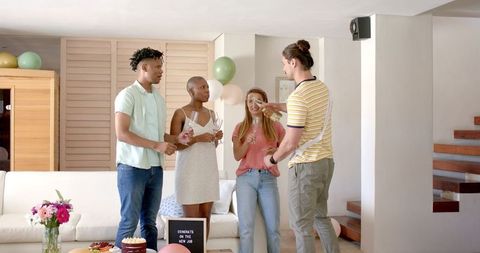 Friends Celebrating Milestone with Champagne at Home Gathering