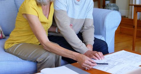 Senior Couple Reviewing Financial Documents at Home