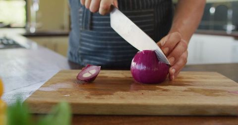 Close-up of Pregnant Woman Chopping Red Onion on Wooden Board